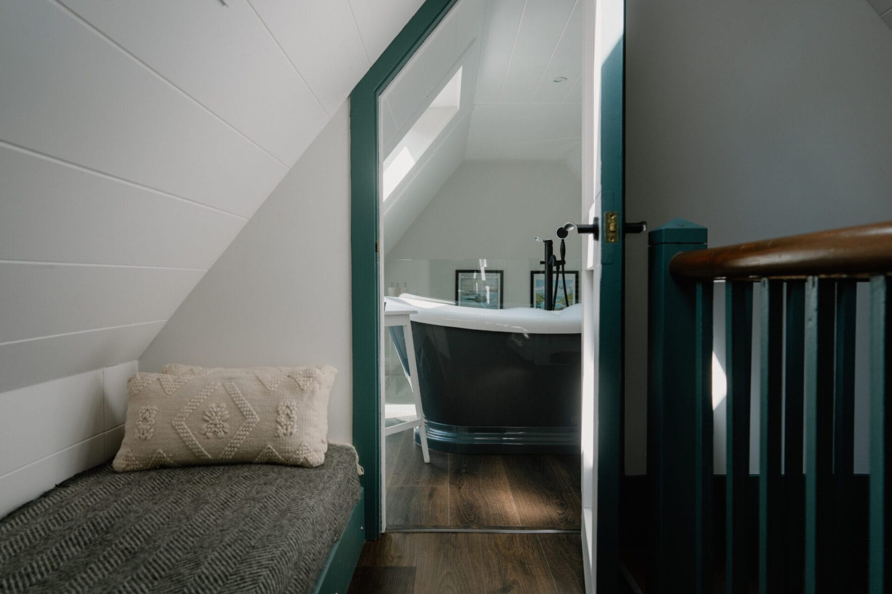 Attic bathroom with freestanding bath and basin at Cairn Valley Cottage, Rothiemurchus, Aviemore