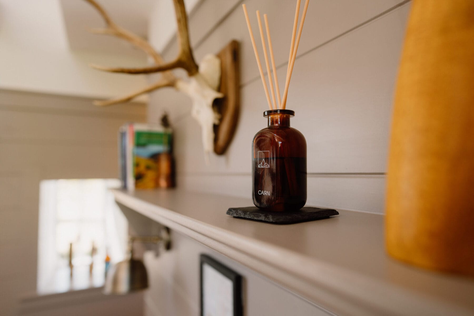 Antlers and candle on a shelf, a Highland detail at Cairn Valley Cottage, Rothiemurchus, Aviemore