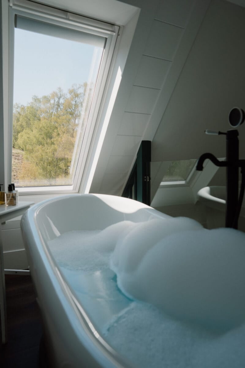 Bubble bath under the skylight at Cairn Valley Cottage, Rothiemurchus, Aviemore