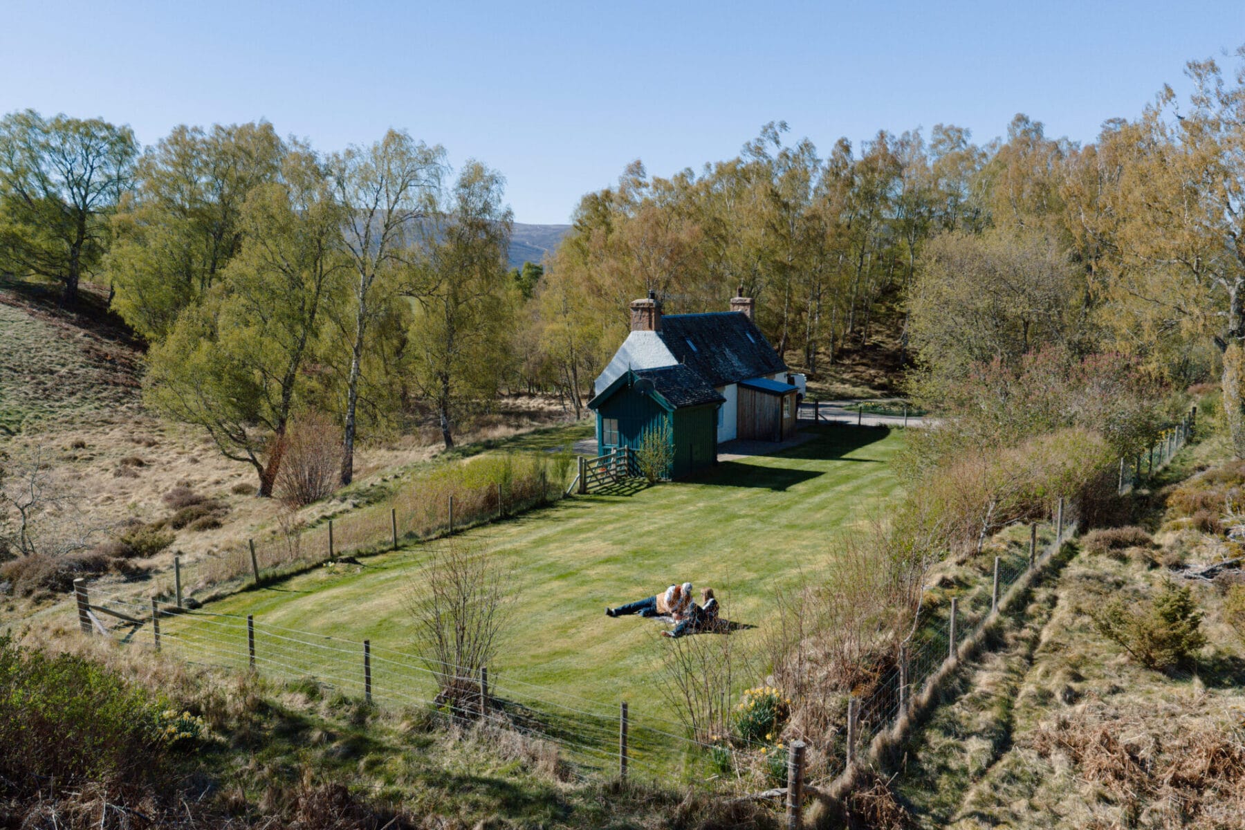 Aerial view of the cottage in its woodland valley at Cairn Valley Cottage, Rothiemurchus, Aviemore