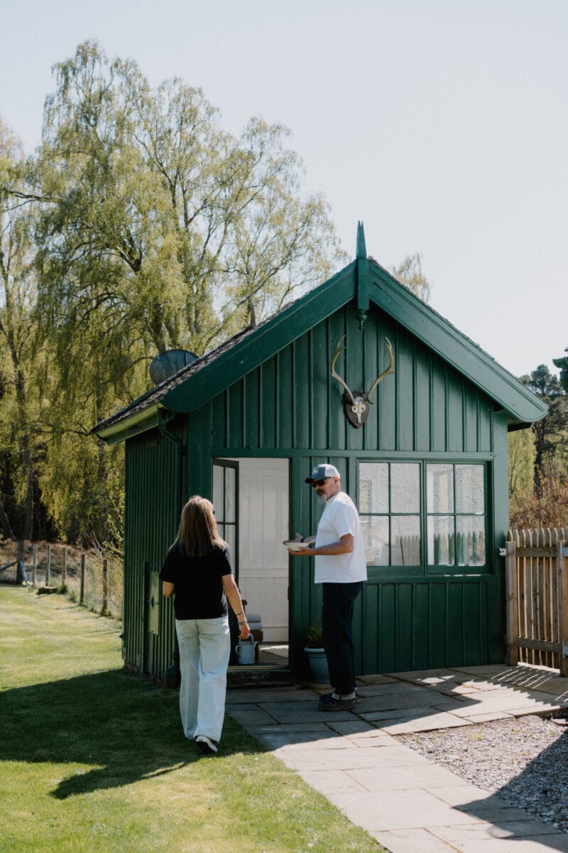 Guests arriving at the green timber garden room at Cairn Valley Cottage, Rothiemurchus, Aviemore