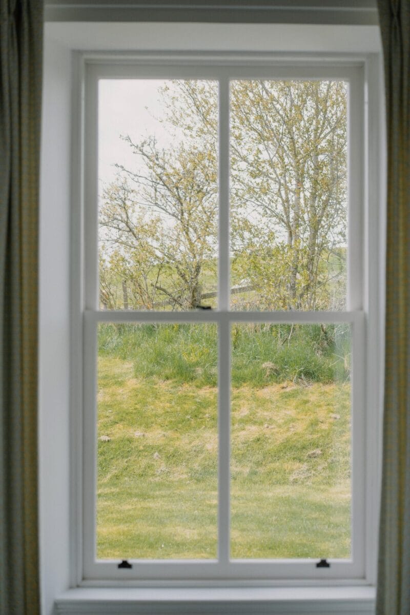 Sash window looking out to the garden at Achnahatnich House, Rothiemurchus, Aviemore