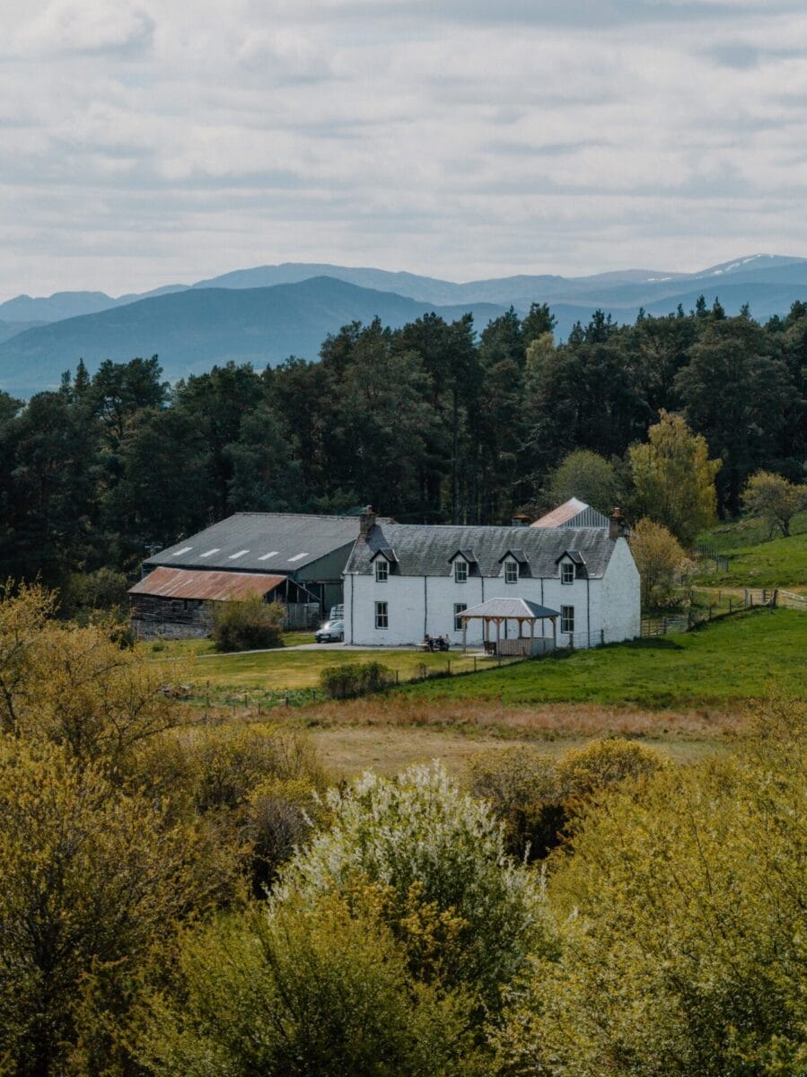 House among birch woodland and hills at Achnahatnich House, Rothiemurchus, Aviemore
