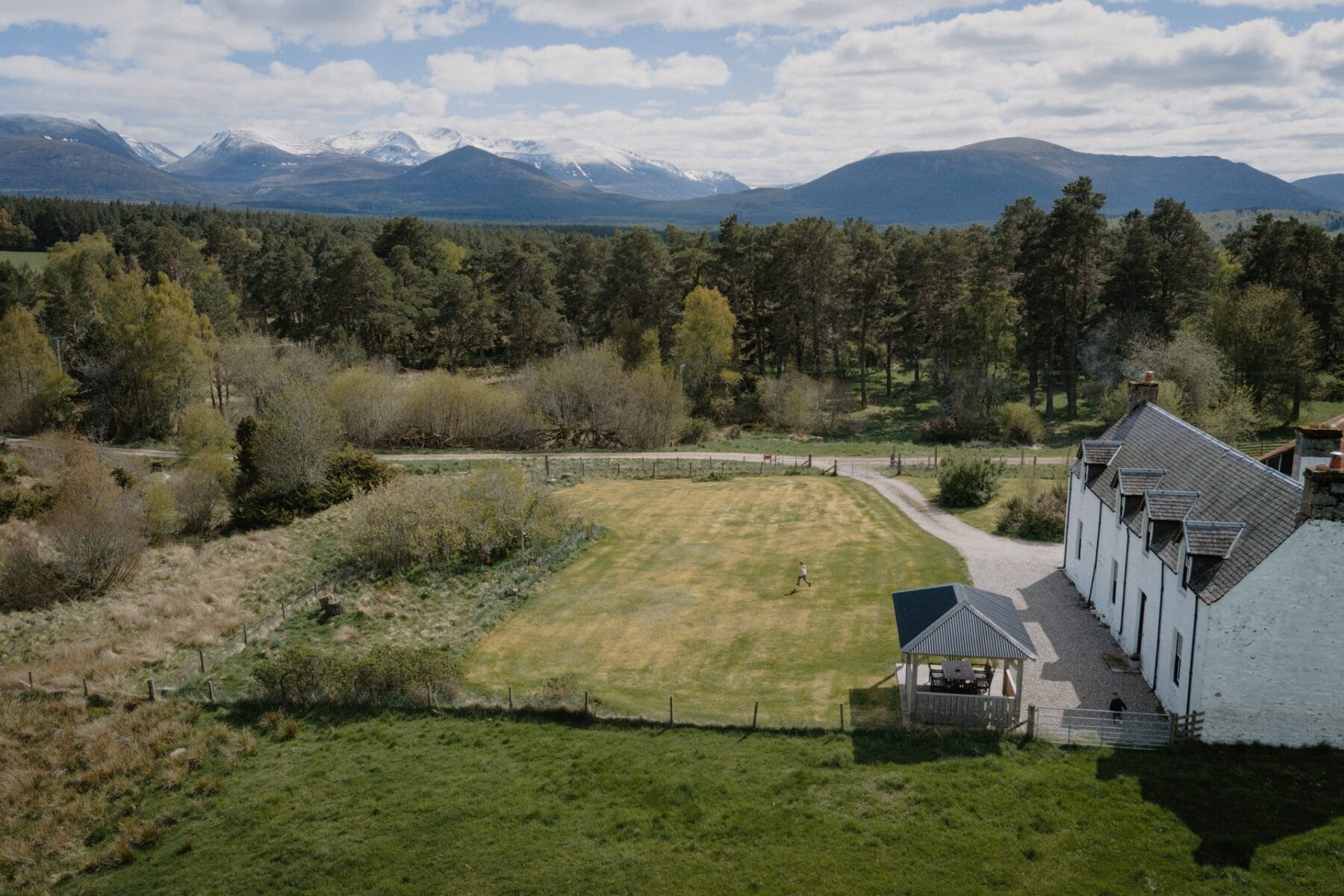 Aerial view of the house and mountains at Achnahatnich House, Rothiemurchus, Aviemore