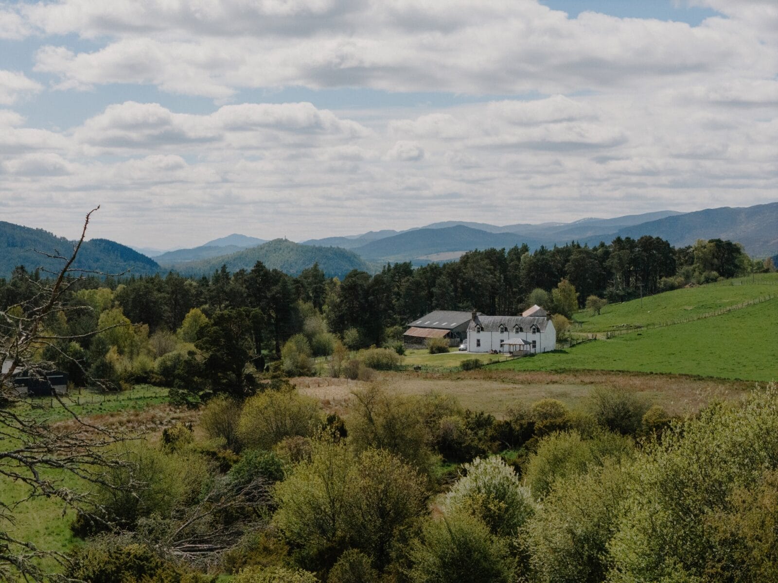 Aerial view of the house and Cairngorm mountains at Achnahatnich House, Rothiemurchus, Aviemore